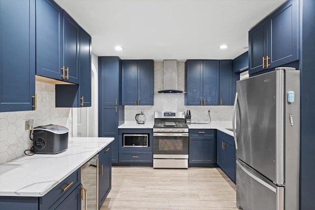 kitchen with blue cabinetry, stainless steel appliances, wine cooler, decorative backsplash, and wall chimney exhaust hood