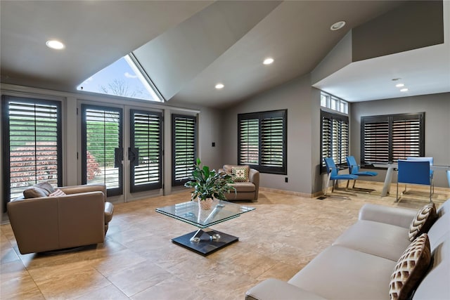 living room featuring a healthy amount of sunlight and vaulted ceiling