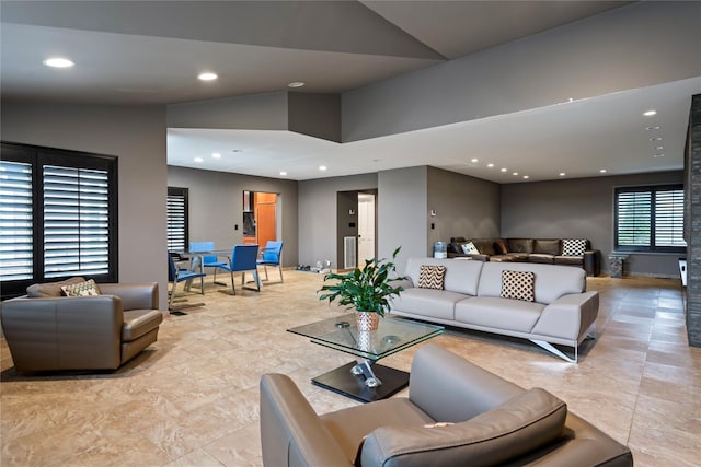 living room with high vaulted ceiling