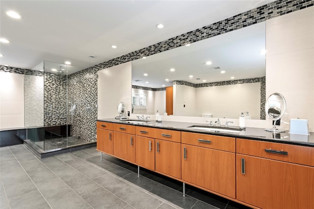 bathroom featuring tile patterned flooring, vanity, and walk in shower