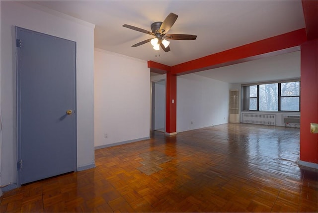 unfurnished room featuring ceiling fan, dark parquet flooring, an AC wall unit, and radiator