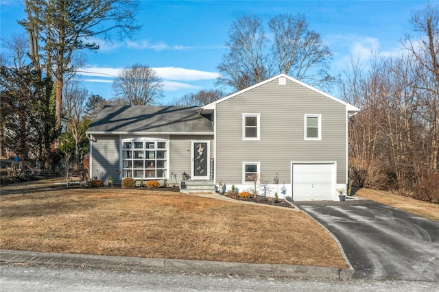 split level home featuring a front yard and a garage