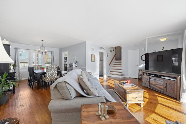 living room with hardwood / wood-style floors and a chandelier