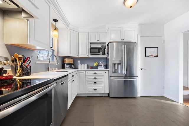 kitchen featuring sink, white cabinets, hanging light fixtures, and appliances with stainless steel finishes