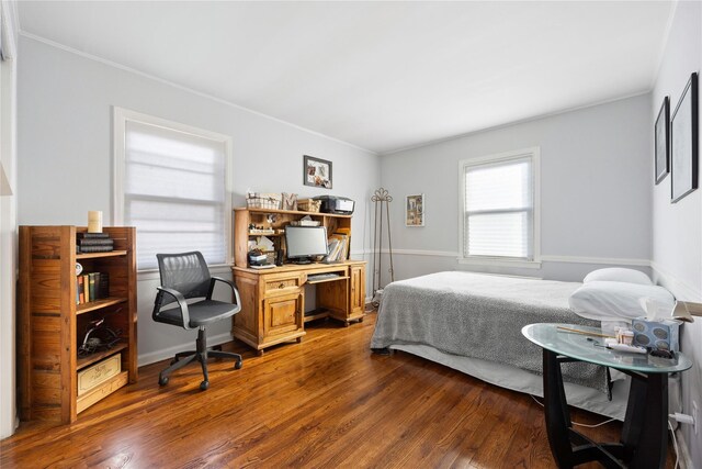 bedroom with dark hardwood / wood-style flooring