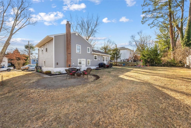 view of side of property featuring a patio area and a yard