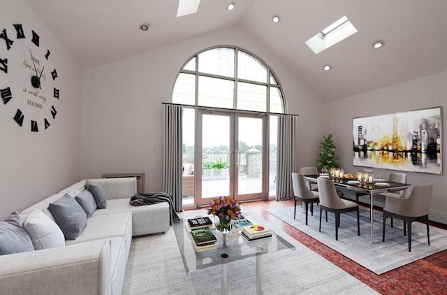 living room with a skylight and high vaulted ceiling