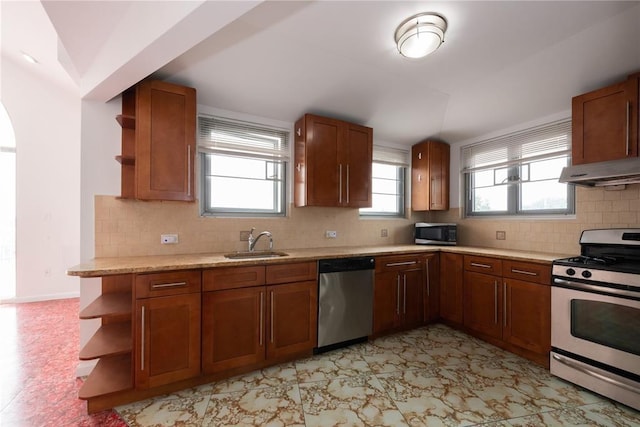 kitchen featuring appliances with stainless steel finishes, tasteful backsplash, and sink