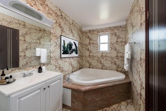 bathroom featuring vanity and tiled tub