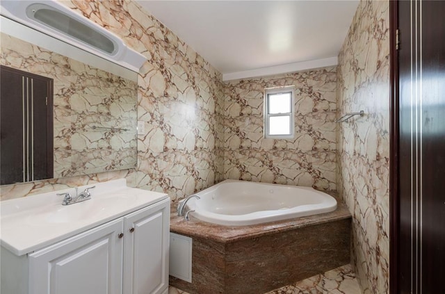 bathroom with tiled bath and vanity