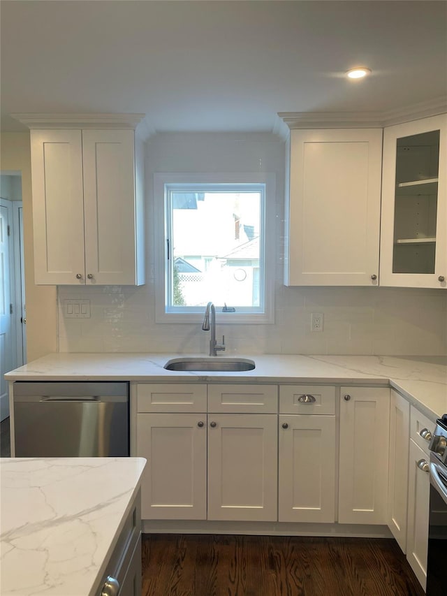 kitchen featuring backsplash, white cabinets, sink, light stone counters, and stainless steel appliances