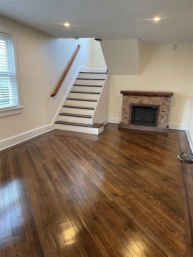 unfurnished living room featuring dark hardwood / wood-style flooring and a fireplace