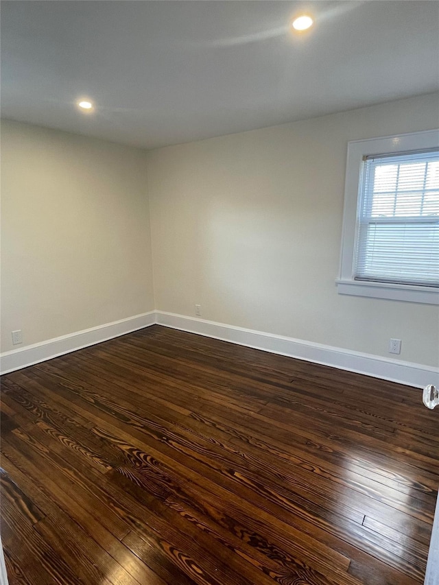 empty room with dark hardwood / wood-style floors