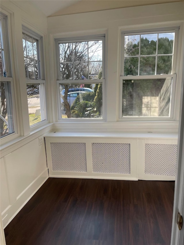 unfurnished sunroom with a healthy amount of sunlight and radiator heating unit