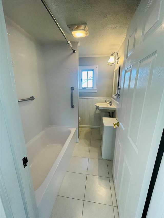 bathroom featuring vanity, tile patterned floors, crown molding, toilet, and a textured ceiling