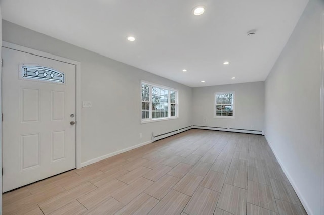 foyer entrance featuring baseboard heating