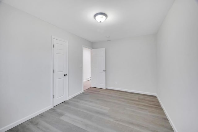 spare room with light hardwood / wood-style floors