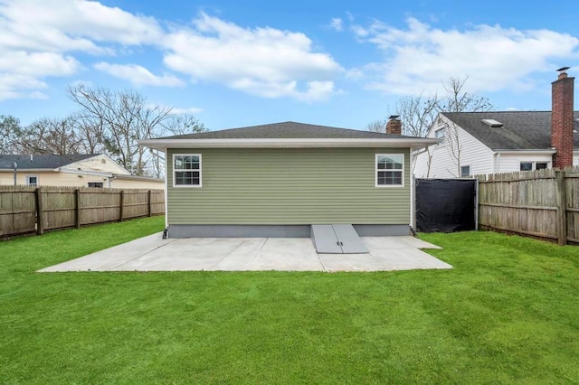 rear view of property featuring a patio and a lawn