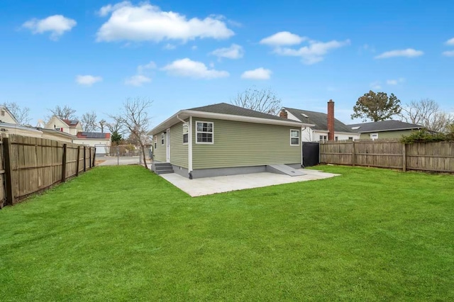 rear view of house with a lawn and a patio