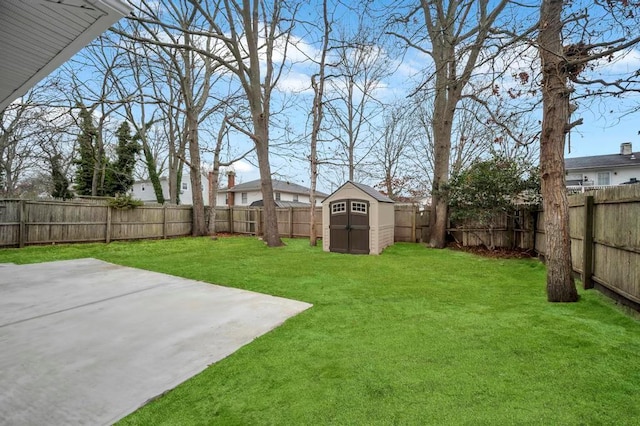 view of yard featuring a storage shed and a patio