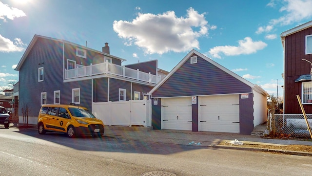 view of front facade with a balcony and a garage