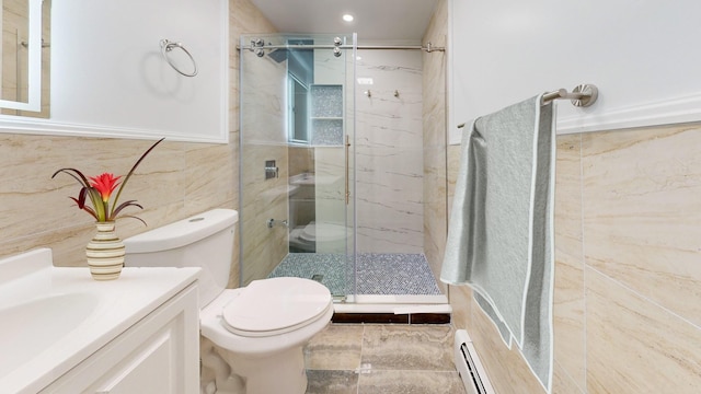 bathroom with vanity, toilet, a shower with shower door, and a baseboard heating unit