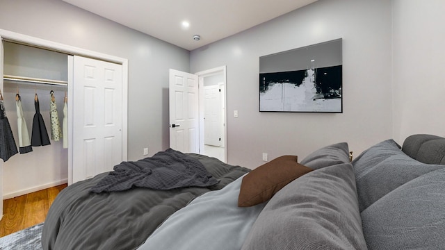 bedroom featuring hardwood / wood-style floors and a closet