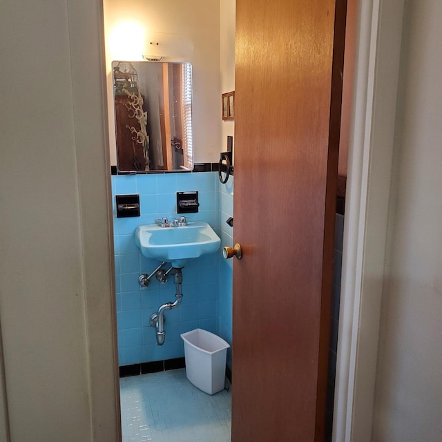 bathroom with tile walls and sink