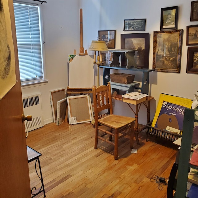 sitting room with light hardwood / wood-style floors and radiator