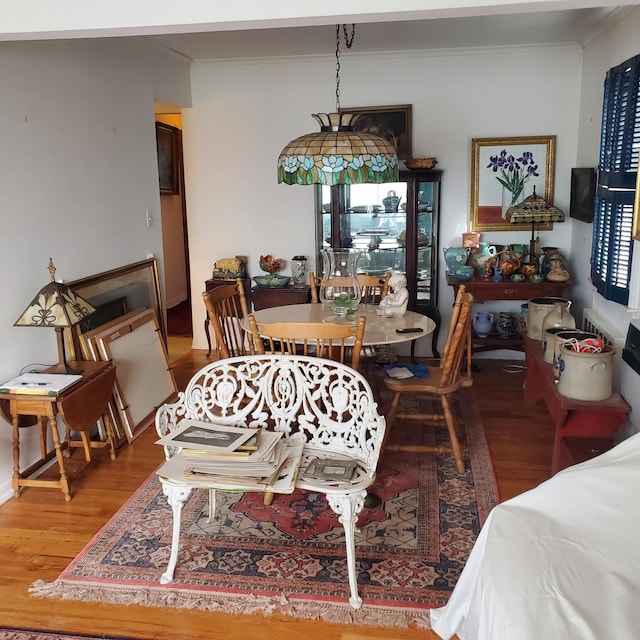 dining room featuring wood-type flooring and crown molding