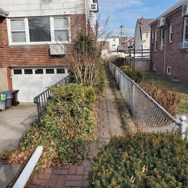 view of side of home with cooling unit and a garage