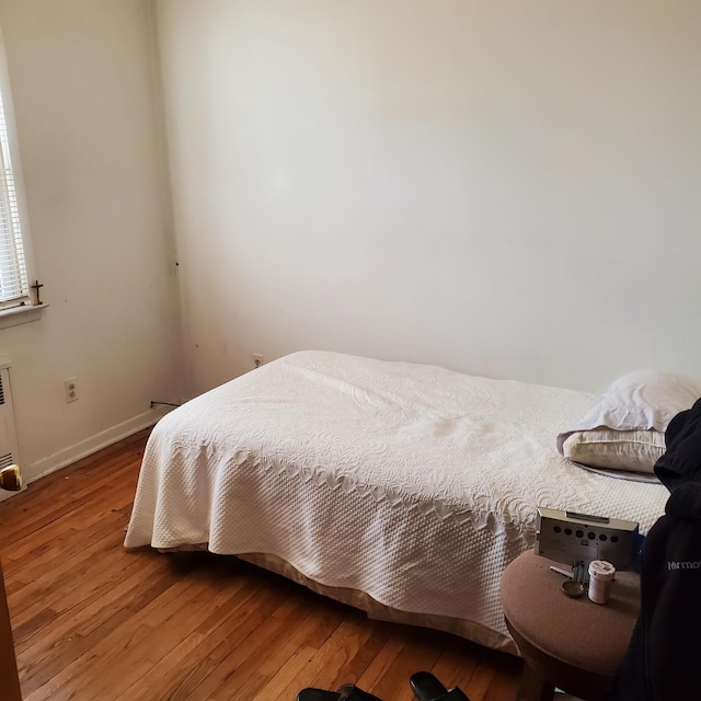 bedroom with hardwood / wood-style flooring