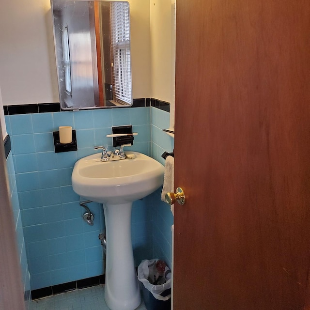 bathroom with sink, tile patterned flooring, and tile walls