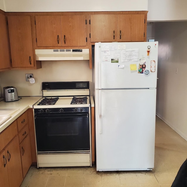 kitchen featuring white fridge and gas range oven