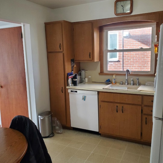 kitchen featuring sink and white appliances