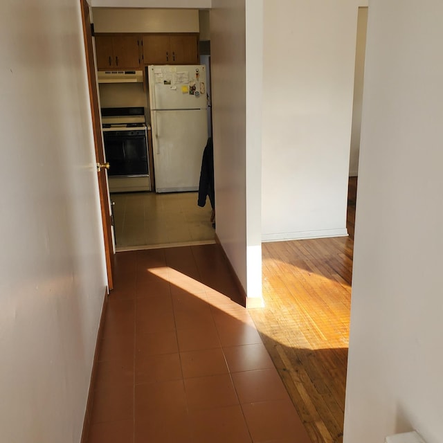 hall with dark tile patterned flooring