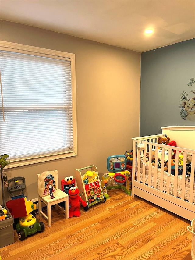 16 Sagewood Dr, Shirley, NY 11967 - bedroom featuring wood finished floors and a crib
