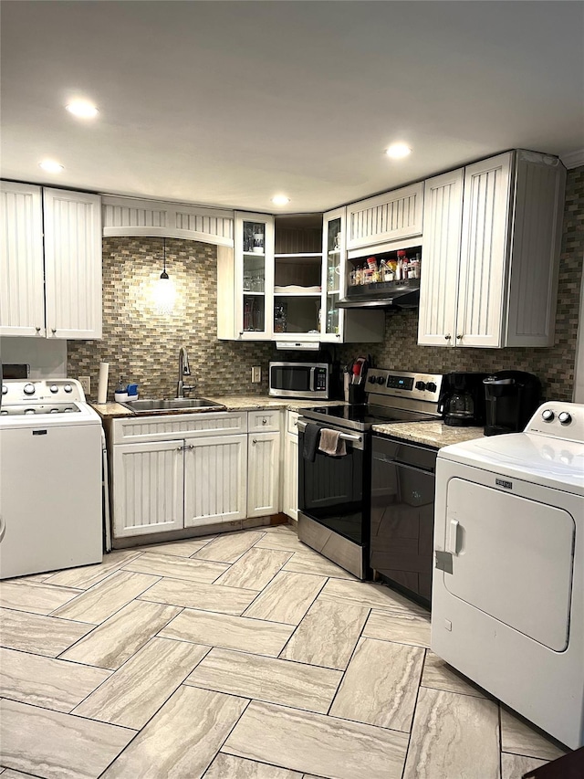 16 Sagewood Dr, Shirley, NY 11967 - kitchen featuring washer / clothes dryer, appliances with stainless steel finishes, a sink, and tasteful backsplash