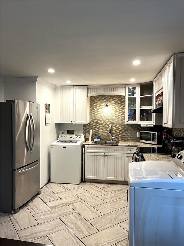 16 Sagewood Dr, Shirley, NY 11967 - kitchen featuring stainless steel appliances, a sink, separate washer and dryer, decorative backsplash, and recessed lighting