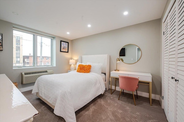 bedroom with dark colored carpet and a wall unit AC