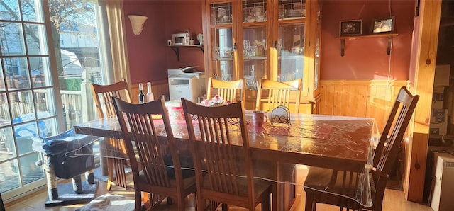 dining space featuring wooden walls