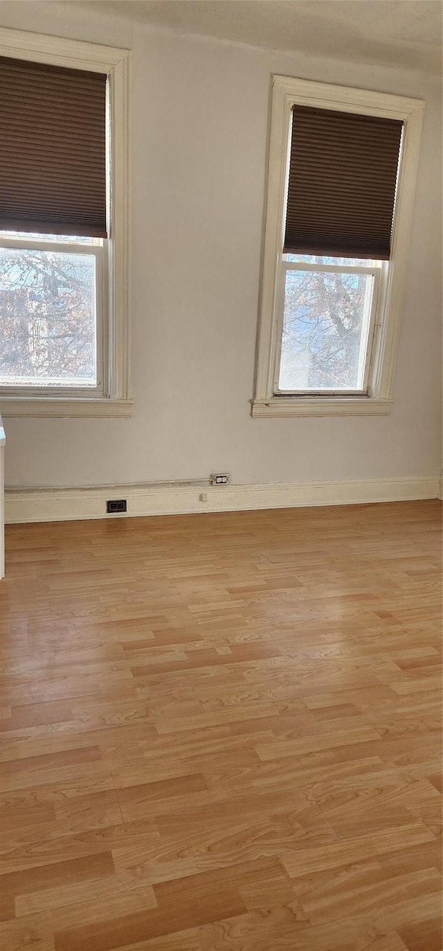 spare room with light hardwood / wood-style flooring