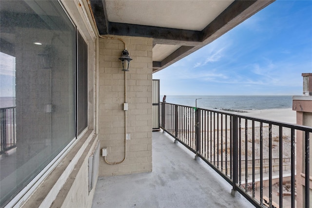 balcony featuring a water view and a view of the beach