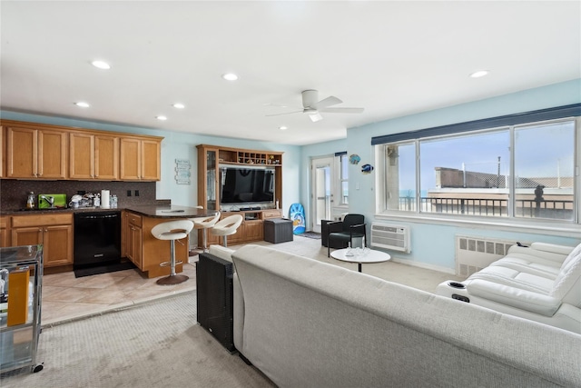 living room featuring ceiling fan, light tile patterned floors, radiator, and a wall unit AC