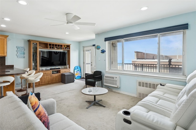 living room with ceiling fan, plenty of natural light, radiator, and a wall unit AC