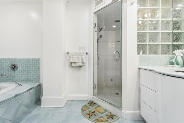 bathroom featuring vanity, independent shower and bath, and tile patterned floors