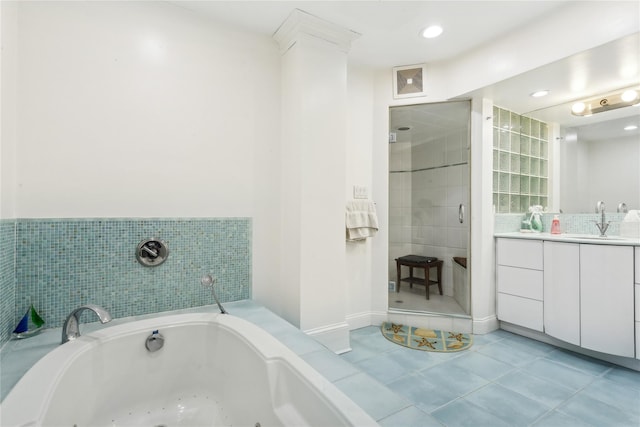 bathroom with tile patterned floors, separate shower and tub, and vanity