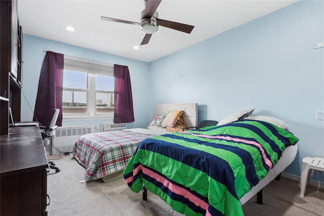 carpeted bedroom with radiator and ceiling fan