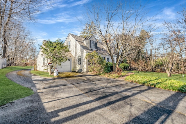 exterior space with a garage and a front lawn