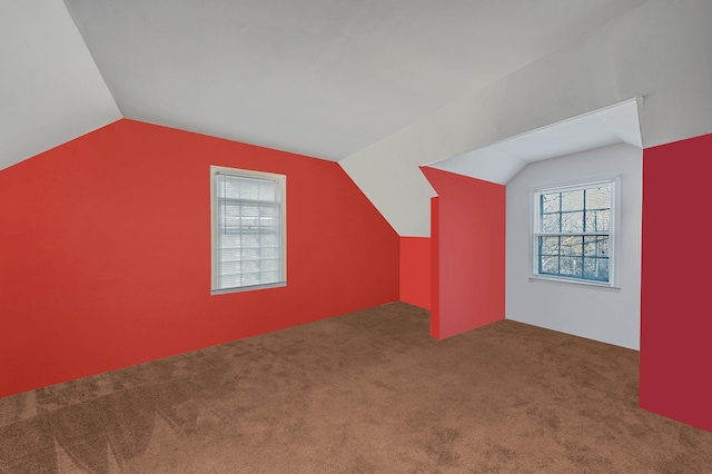 bonus room featuring lofted ceiling and carpet flooring